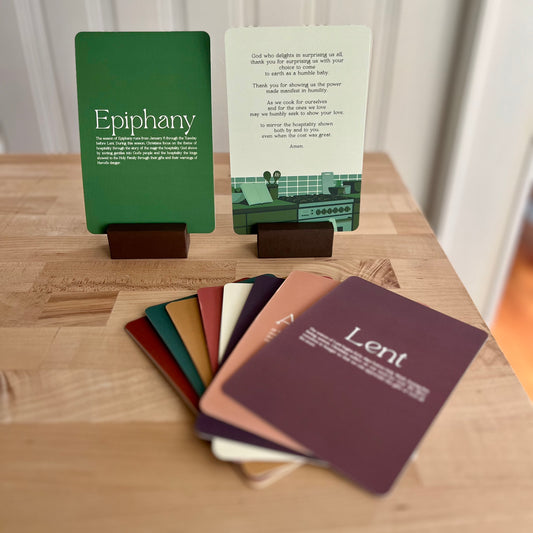 green prayer cards with the word epiphany standing up in a wooden stand, colorful cards spread out in front of it