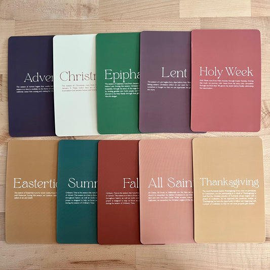 Set of color swatches with religious terms on a wooden surface