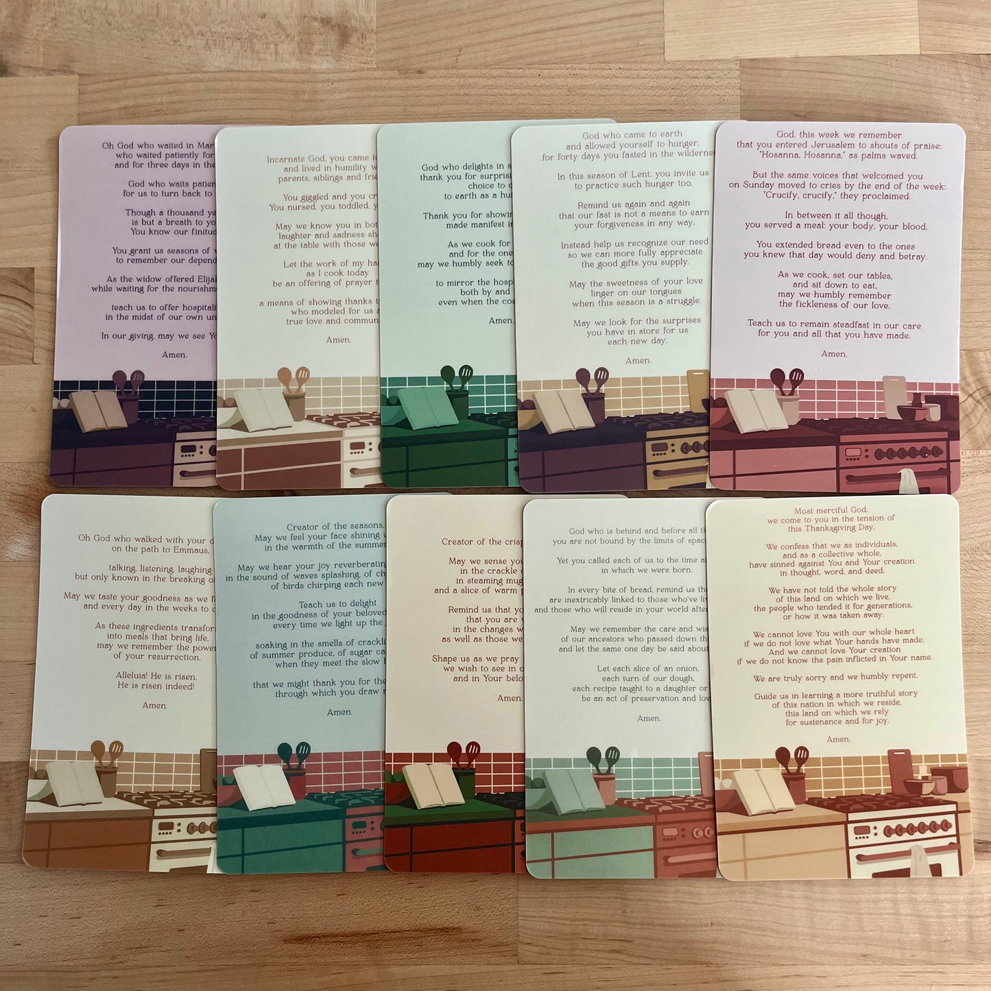Set of cards with illustrated scenes and text on a wooden surface