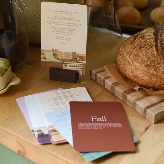 Kitchen counter with bread, cards, and a measuring cup